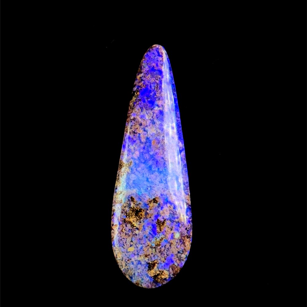 A polished purple and blue boulder opal teardrop.