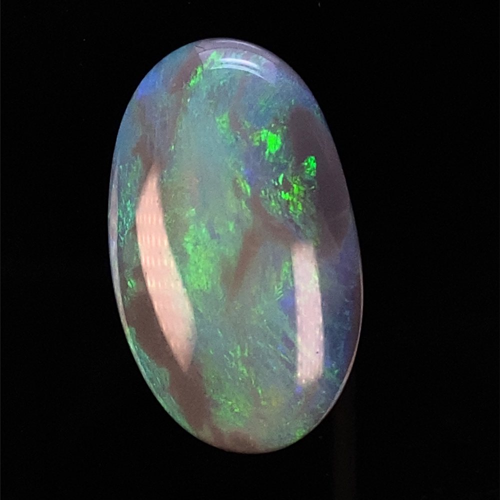 A dark-base opal with electric blue and green colour.