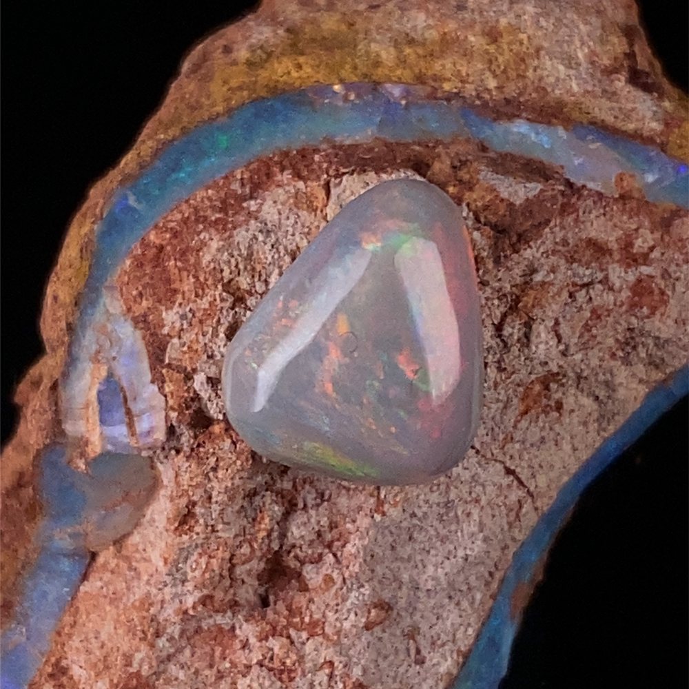 A polished opal seam held in its host rock.