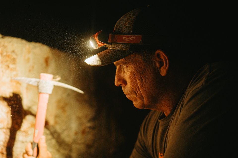Dan reading an underground mine face by headlamp.